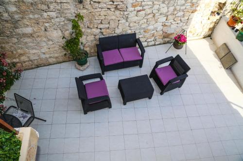 an overhead view of a patio with purple and black chairs at Apartments Seka in Hvar