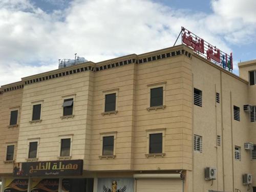 ein Gebäude mit einem Schild darüber in der Unterkunft Alwan apartment hotel in Chamis Muschait