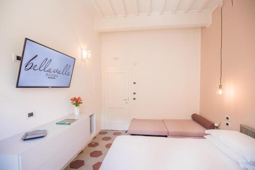 a white bedroom with a bed and a couch at Bellavalle ROOMS Vinci Florence Tuscany in Vinci