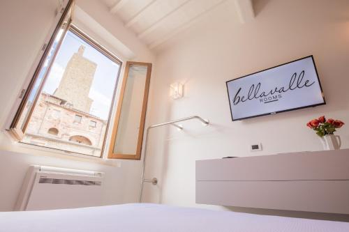 a bedroom with a white refrigerator and a window at Bellavalle ROOMS Vinci Florence Tuscany in Vinci