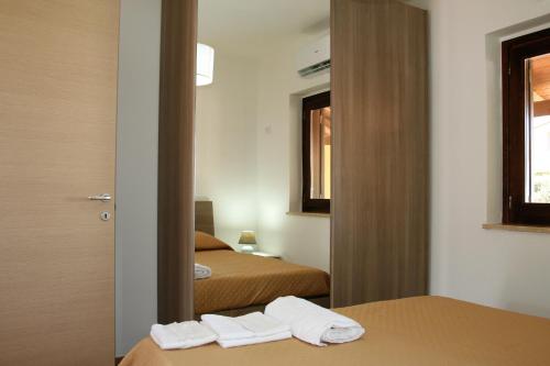 Postel nebo postele na pokoji v ubytování Portoada Park Villas