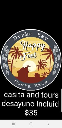 a sign for a restaurant with a beach and palm trees at Casita happy feet and tours corcovado in Drake