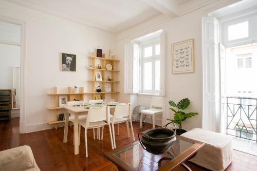 a living room with a table and a dining room at Caraujo Apartments in Lisbon