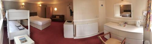 a small room with a bed and a bathroom at The Highfield Hotel in Bradford