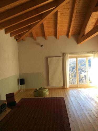 a living room with a rug on the floor and a large window at B&B Al Giardino Dei Mandorli in Prasco