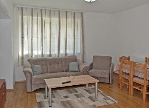 a living room with a couch and a chair and a table at MS Apartment in Ohrid