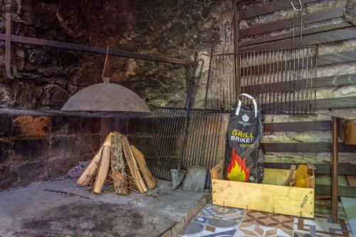 a room with a grill with a bag of fire at Mediterranean terrace apartment with Bikes & SUP in Skradin
