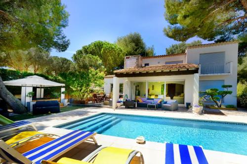 a villa with a swimming pool and a house at Villa Aurelie in Cap d'Agde