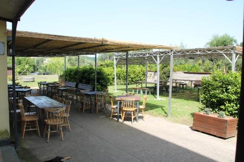 a group of tables and chairs under a pavilion at Agriturismo Piccolo Paradiso in Piano di Sorrento