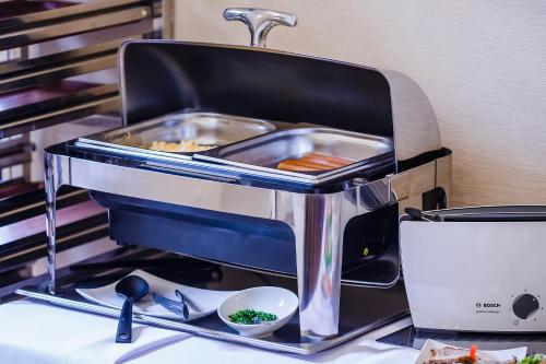 a toaster sitting on top of a counter with food at Boutique Hotel's III Piłsudskiego in Łódź