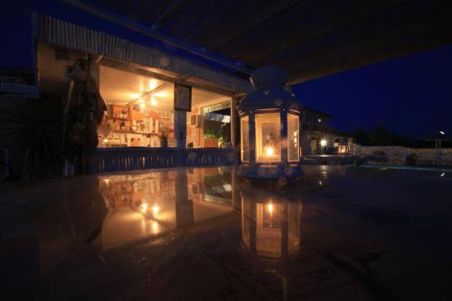 a lantern on the patio of a house at night at MORF suites in Casale Marittimo