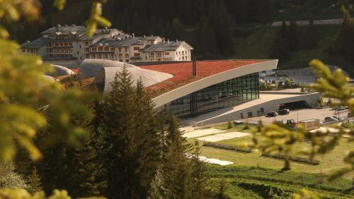 a large building with a red roof on top of it at Studio à Courchevel Moriond in Saint-Bon-Tarentaise