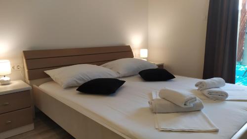 a bed with two towels and two pillows on it at Apartment Skavo in Baška Voda