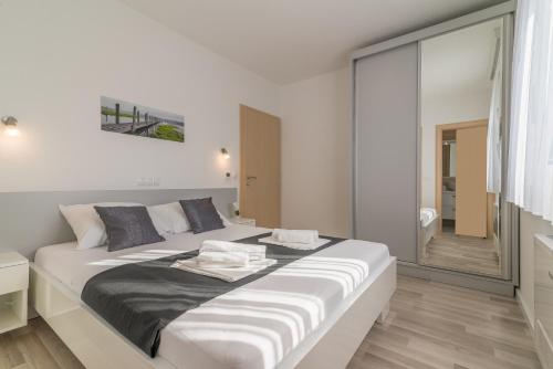 a bedroom with a large bed and a bathroom at VILLA SOFIJA in Zaton
