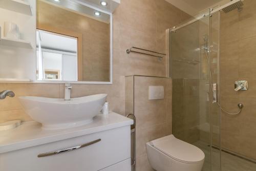 a bathroom with a toilet and a sink and a shower at VILLA SOFIJA in Zaton