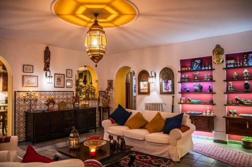 a living room with a couch and a chandelier at Attico rooms in Giardini Naxos