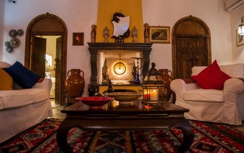 a living room with a table and a fireplace at Attico rooms in Giardini Naxos