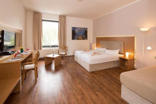 Postel nebo postele na pokoji v ubytování T3 Hotel Cityloft