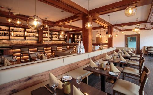 a restaurant with tables and chairs and a bar at Forsthof in Steinheim an der Murr