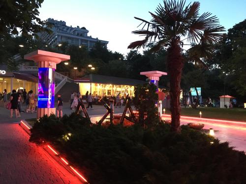 a group of people walking down a street at night at квартира в Аркадии in Odesa
