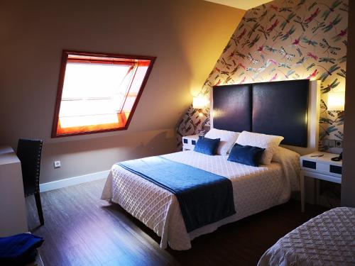 Кровать или кровати в номере Hotel Boutique Aquaria Caneliñas