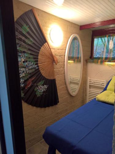 a room with a bed and two mirrors on the wall at Tamerici House in Montecastrilli