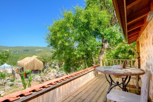 a wooden balcony with a table on a deck at 3 Oda Kaş in Kas