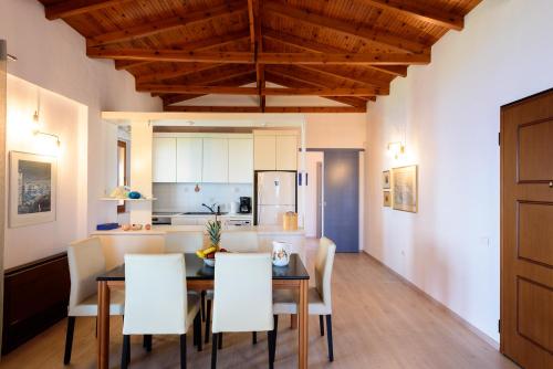 a dining room and kitchen with a table and chairs at Finisia House in Elia Laconias