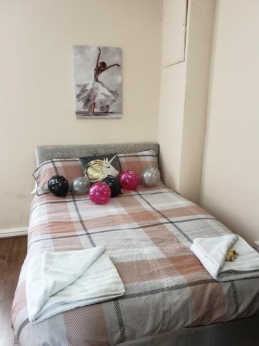 a bed in a bedroom with a blanket and a picture at The Winter Garden Suites in Blackpool