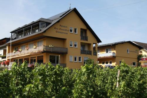 a building with a bunch of trees in front of it at Haus Klosterblick in Kröv