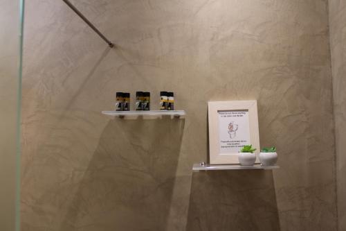 a shelf with three bottles of wine on a wall at Theater Penthouse in Corfu Town