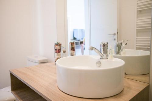 a bathroom with a white sink and a mirror at Pensiunea Sada in Cluj-Napoca