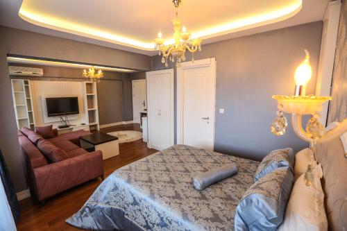 a bedroom with a bed and a living room at Thermal Saray Hotel & Yalova in Gokcedere