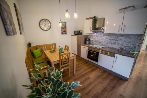 a kitchen with a table and a dining room at Ferienhaus am Apfelbaum in Andernach