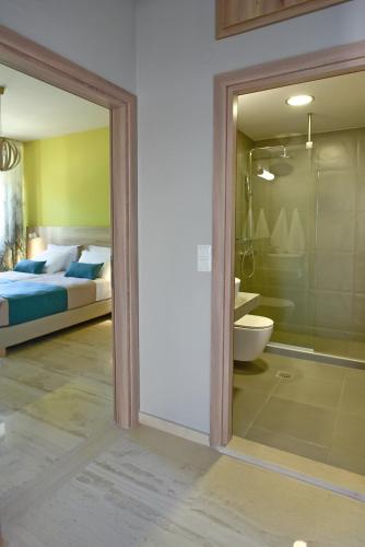 a bedroom with a bed and a sliding glass door at Plakias Riviera in Plakias
