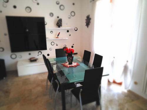 a dining room with a table with chairs and a television at Dolce Risveglio in San Valentino in Abruzzo Citeriore
