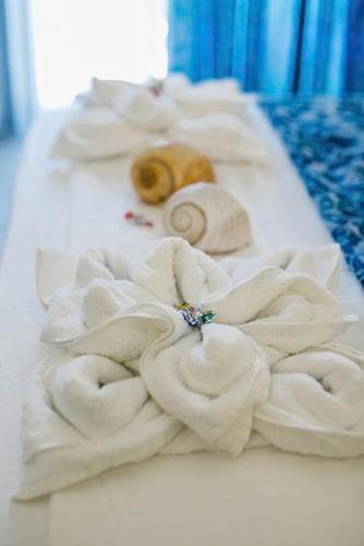 a pile of towels and a donut on a table at Frangeo boutique rooms in Asprovalta