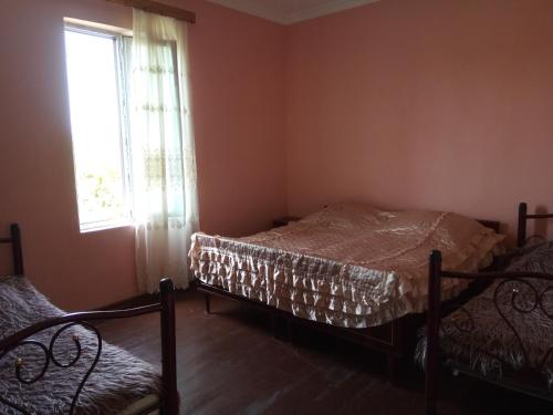 Postel nebo postele na pokoji v ubytování Julia Guest House