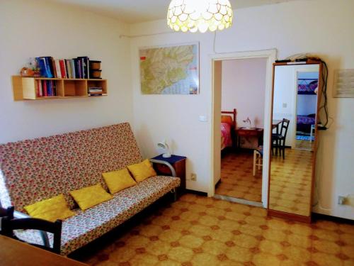 a living room with a couch and a bedroom at Casa La Quiete in Orco Feglino