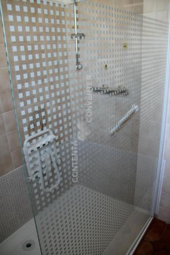 a shower with a glass door in a bathroom at Le Gîte des Moulins in Nissan-lez-Enserune