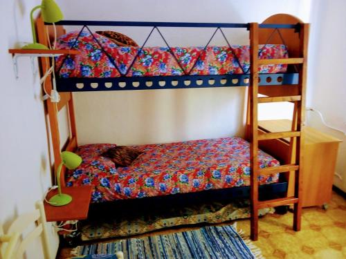 a bedroom with two bunk beds and a ladder at Casa La Quiete in Orco Feglino