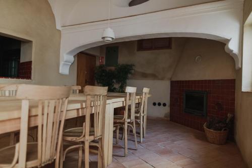 a kitchen with a table and chairs and a fireplace at La Hermandad de Villalba in Villalba de los Barros