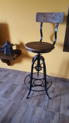 a wooden chair sitting on top of a wooden floor at Rifugio della Pace Piano terra e Primo Piano in Sant' Isidoro