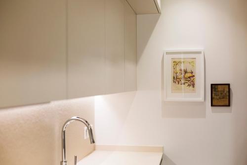 a white kitchen with a sink and a faucet at Hontza by Smiling Rentals in Hondarribia