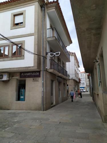 a building with a sign on the side of a street at EL RINCON DE LUZ in Padrón