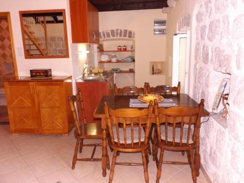 a kitchen and dining room with a table and chairs at Gudelj Apartments in Perast