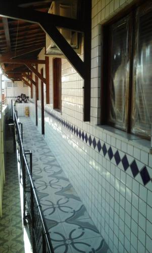 a tiled hallway of a building with a tile floor at Suítes Centro Praia in Fortaleza