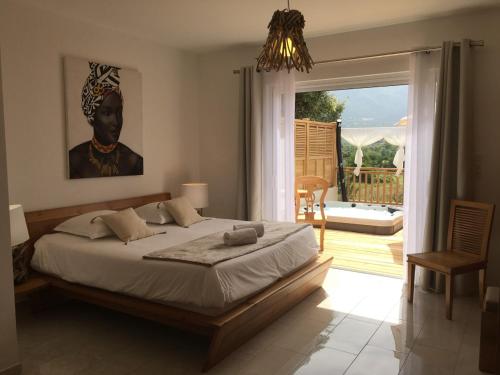 a bedroom with a bed and a view of a patio at Villa Torrella in Mezzavia