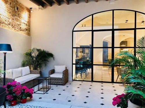a living room with a large window and a patio at Hotel Basilica in Palma de Mallorca