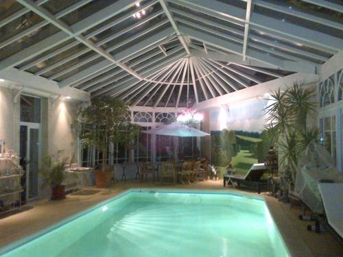 a swimming pool in a house with a ceiling at Maison du Théâtre Saint Bonnet in Bourges